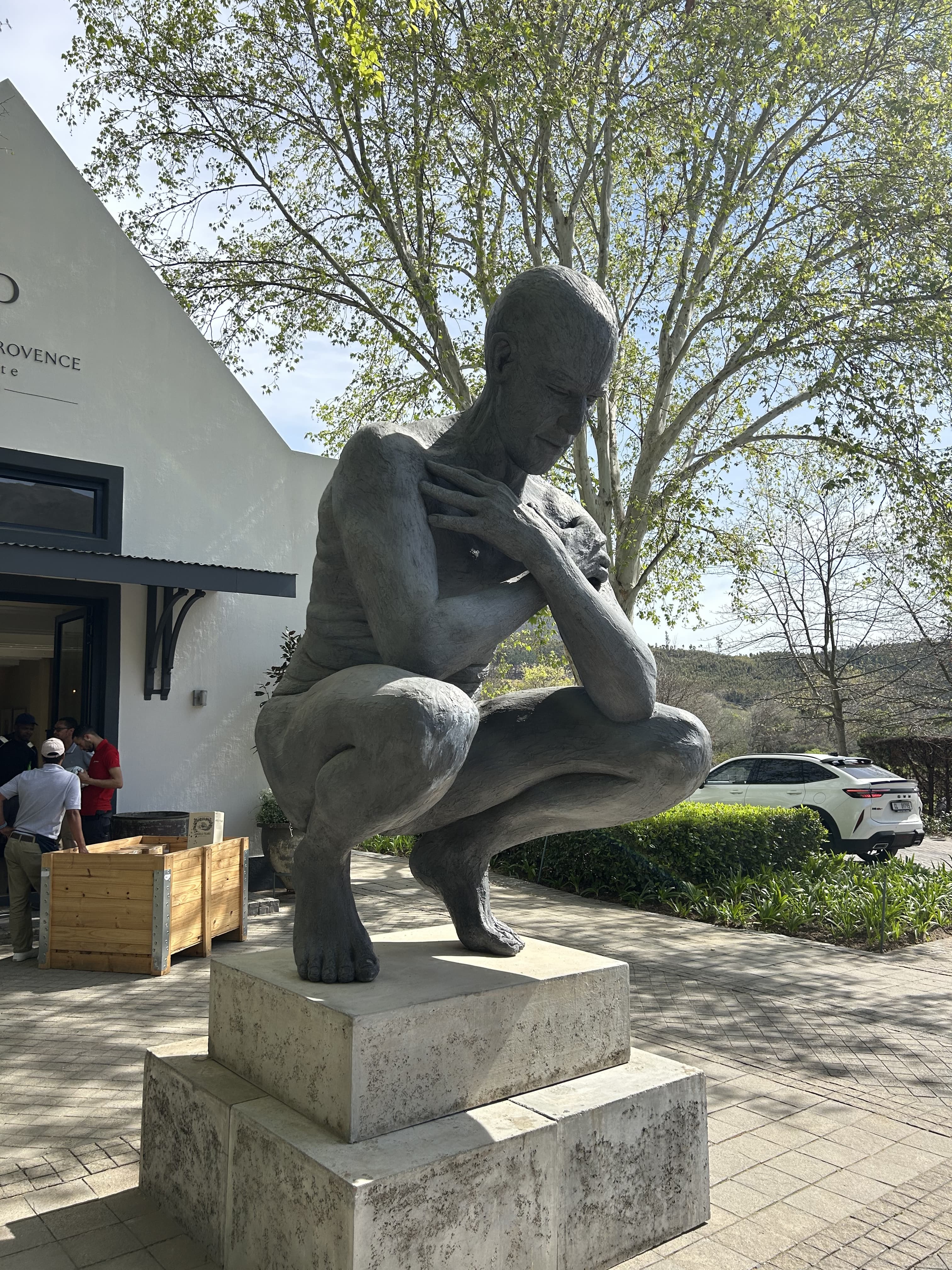 Sculpture of a figure reading outside a building, Cape Town