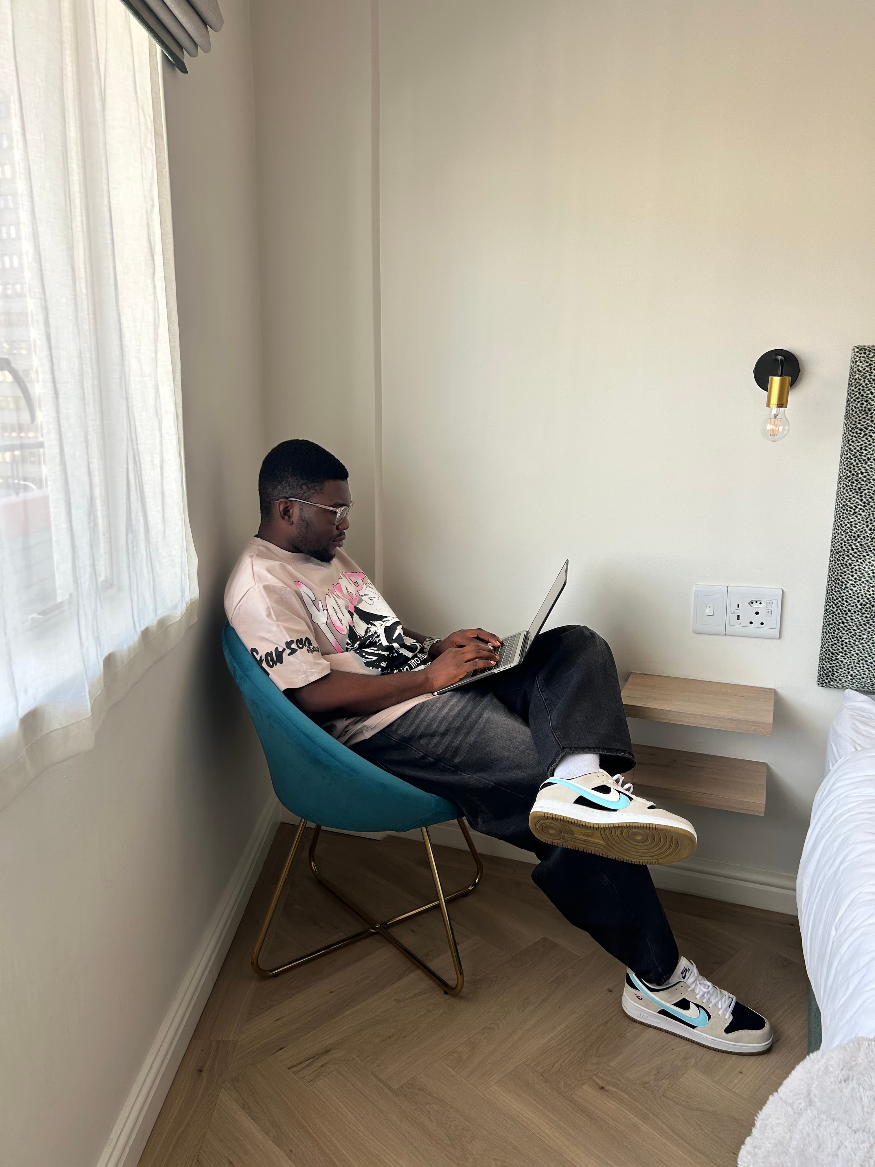 Relaxing in a teal chair in a hotel room, Cape Town